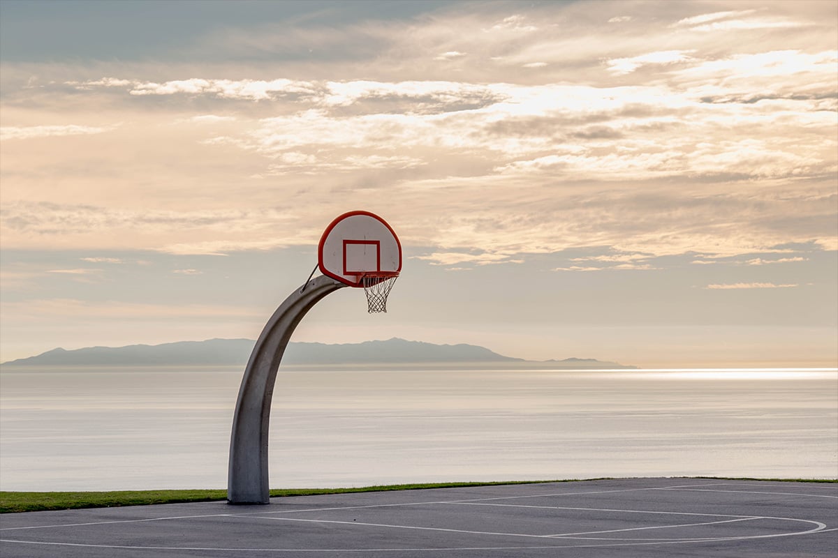 A basketball hoop located on the beach