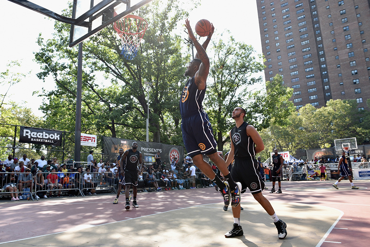 Basketball player dunking at Rucker Park