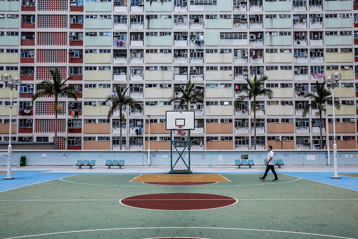 Basketball court in front of a big rainbow-colored building